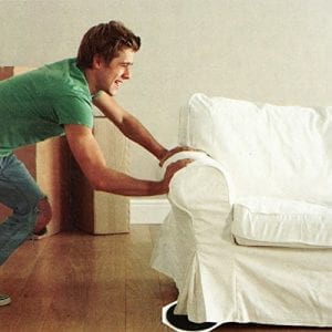 young man struggling to move furniture
